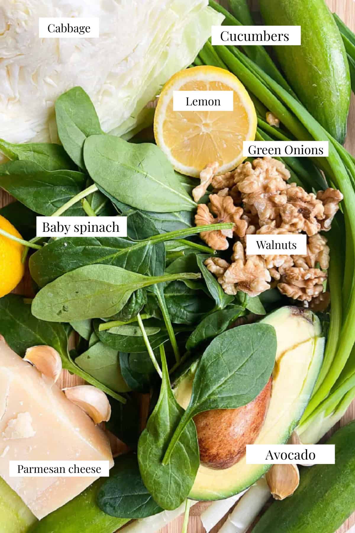 ingredients shot with cabbage spinach lemon avocado green onions walnuts and parmesan.