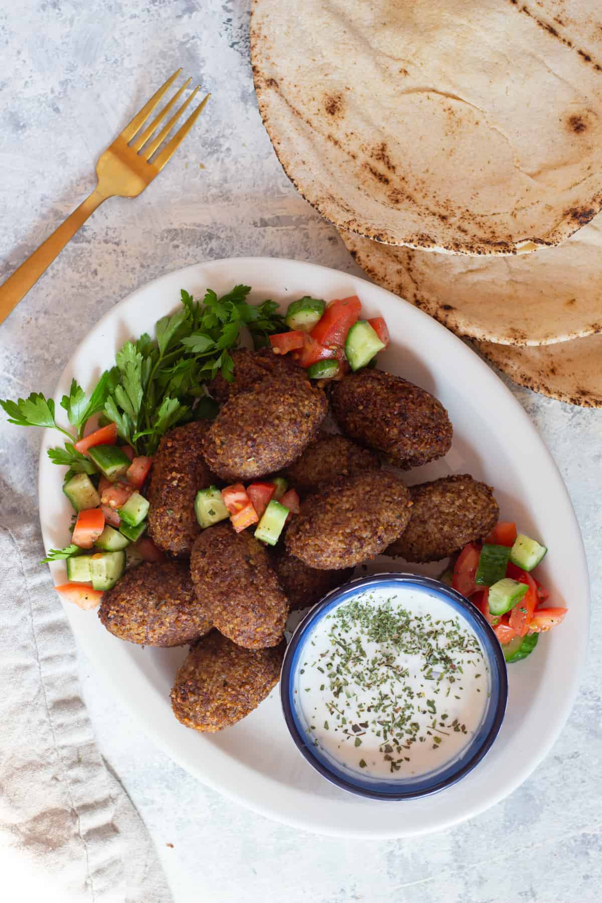 fried kibbeh is shaped like a football or a croquette. 