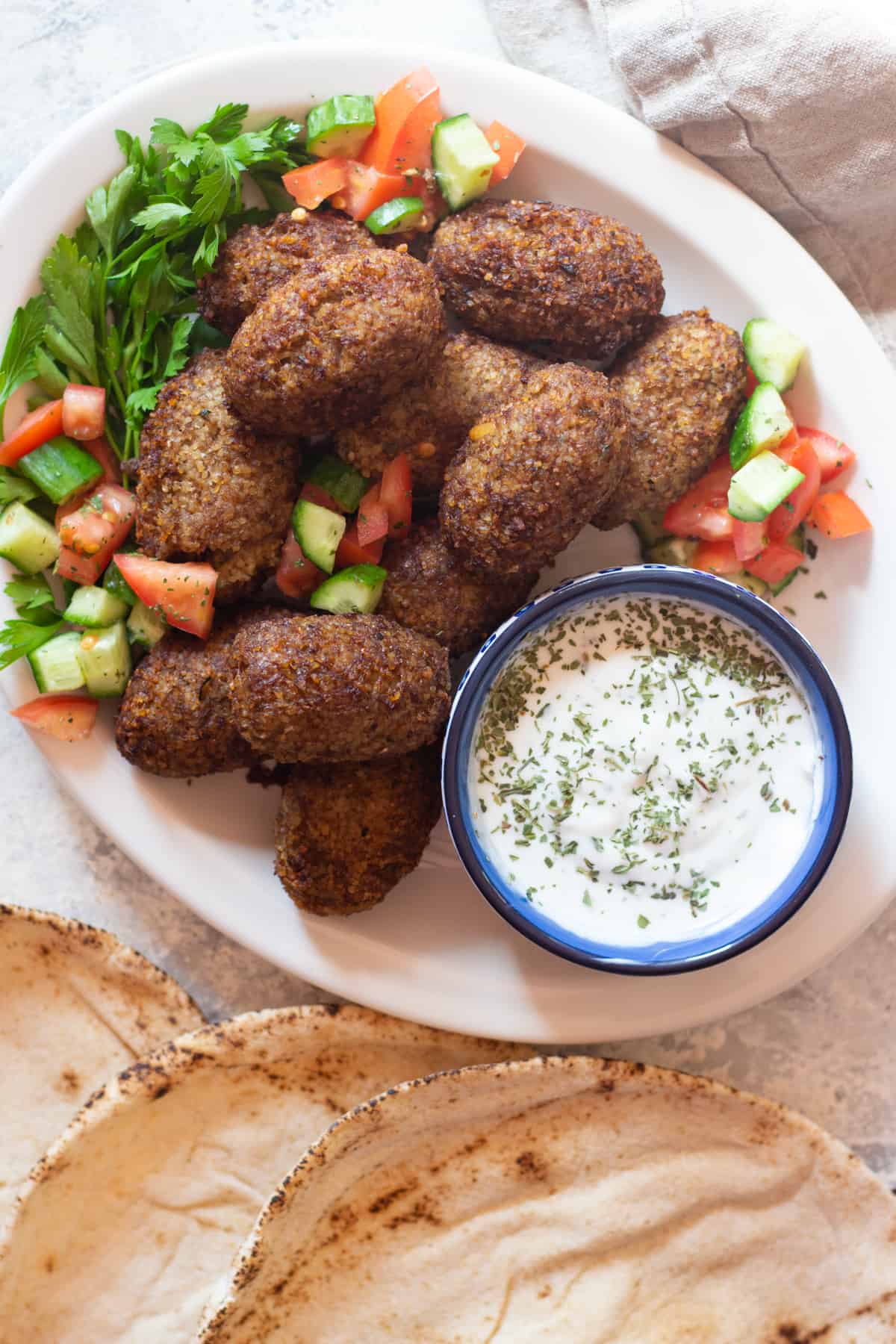Kibbeh is a Middle Eastern dish made of bulgur, ground beef and warm spices. Learn how to make this kibbeh recipe with this step-by-step tutorial and video. Kibbeh is made of a tender shell stuffed with a delicious spiced filling and is full of amazing Middle Eastern flavors.