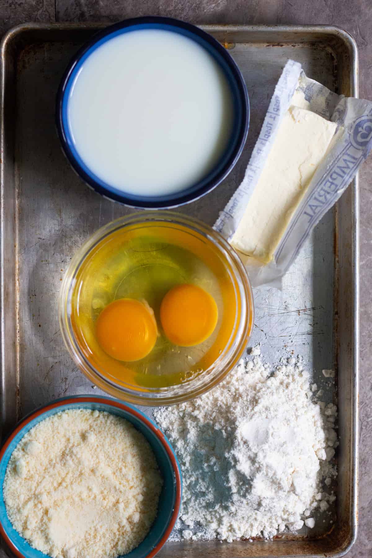 To make bechamel sauce for moussaka you need butter, flour, milk, eggs and parmesan cheese. 