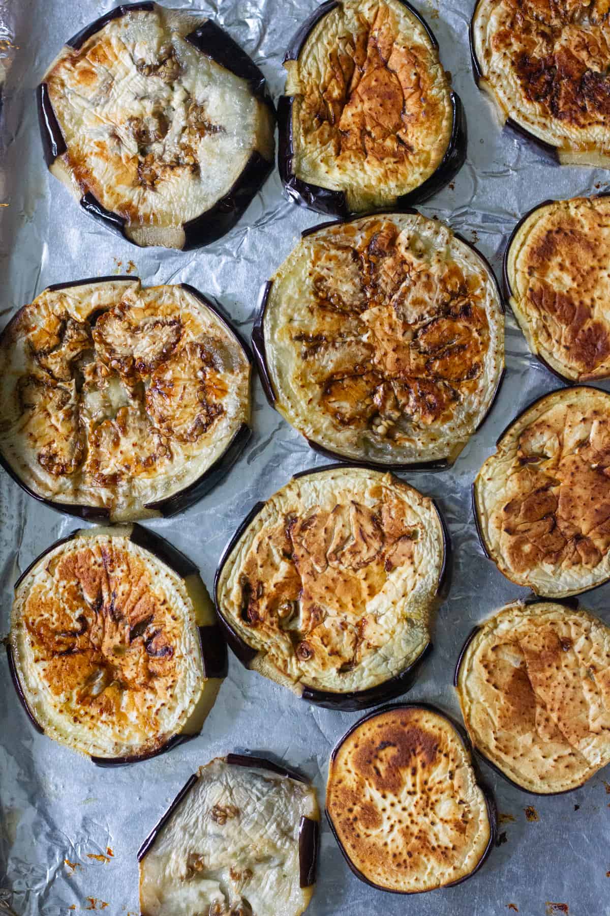 Roast the eggplant slices in the oven. 