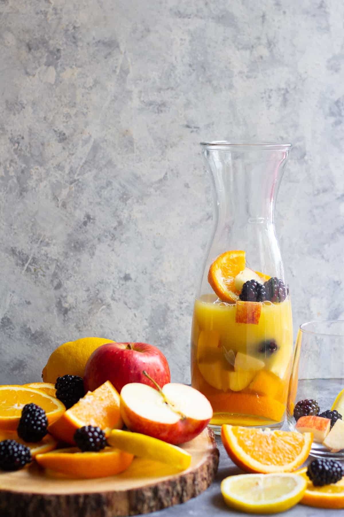 Cut up the fruit and add it to a pitcher. Add orange juice to the pitcher. 