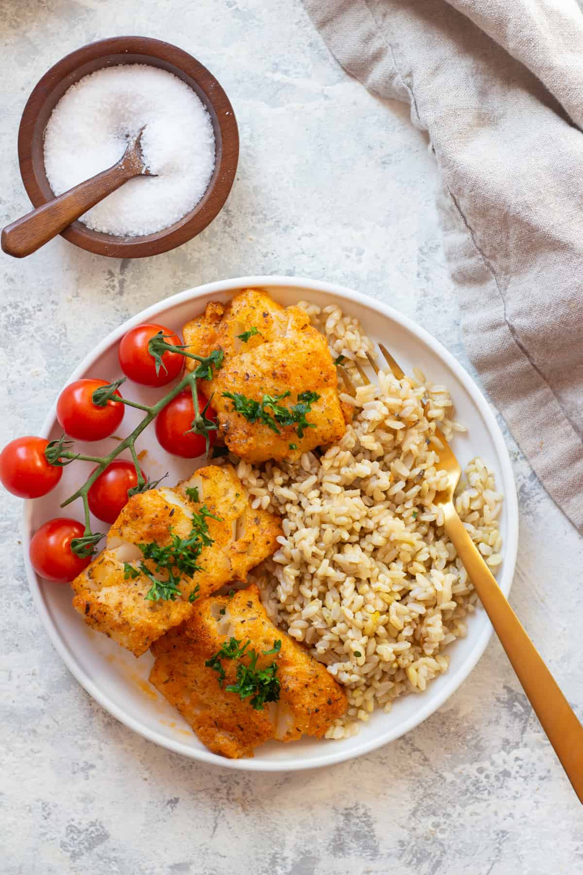 A plate of baked cod with rice makes a healthy dinner that you can make in less than 30 minutes