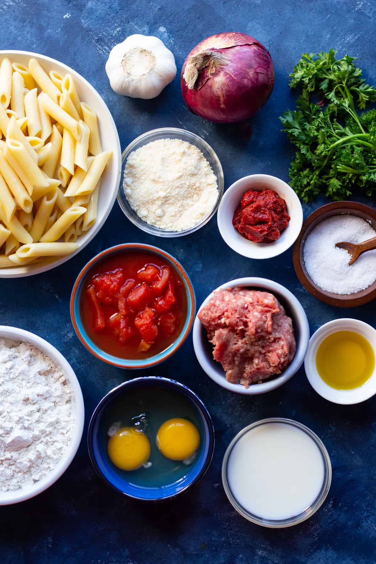 To make pastitsio recipe at home you need onion, pasta, beef and lamb plus tomatoes, eggs, spices, flour and milk.