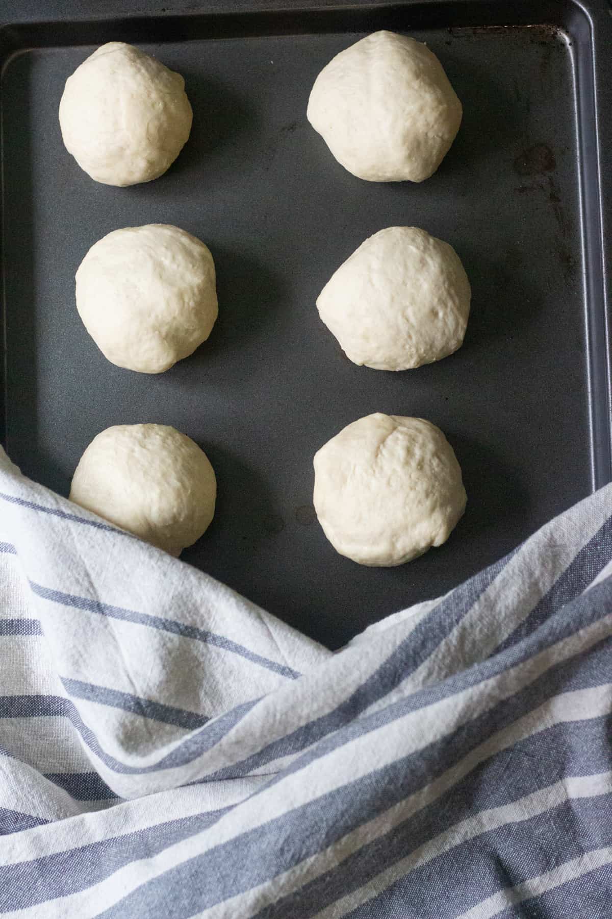 Deflate the dough gently and divide into 8 pieces. Shape each piece into a ball. 