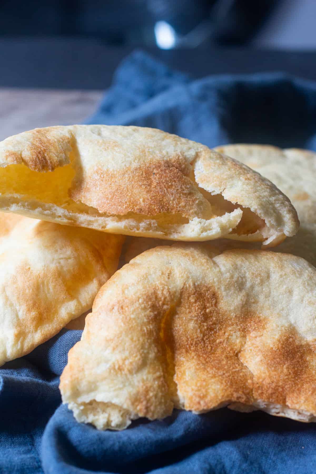 Recipe for pita bread. A few pita breads on a kitchen towel. 