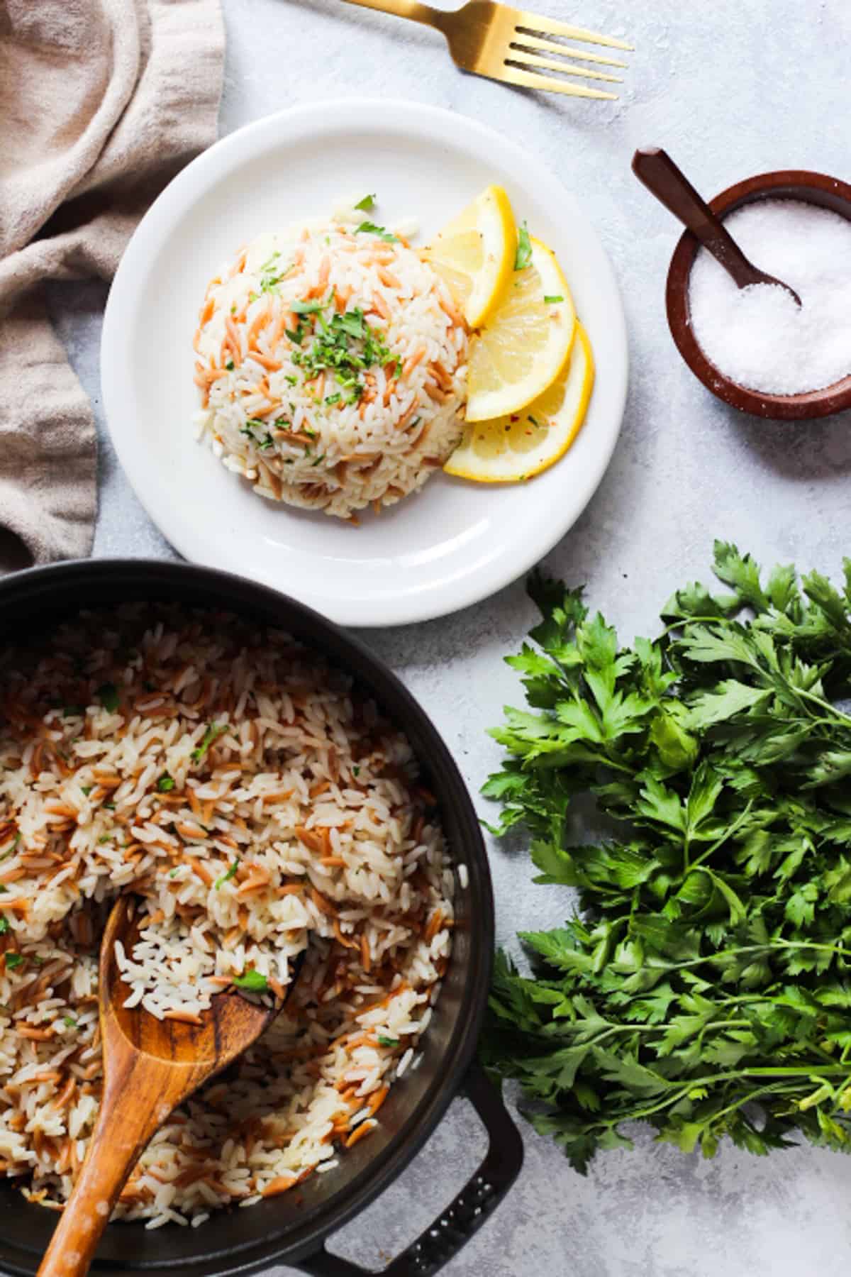 A pot of fluffy rice pilaf and herbs. 