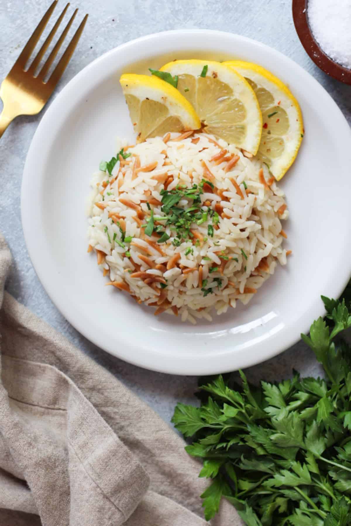 Turkish rice pilaf with orzo served with a few lemon slices. 