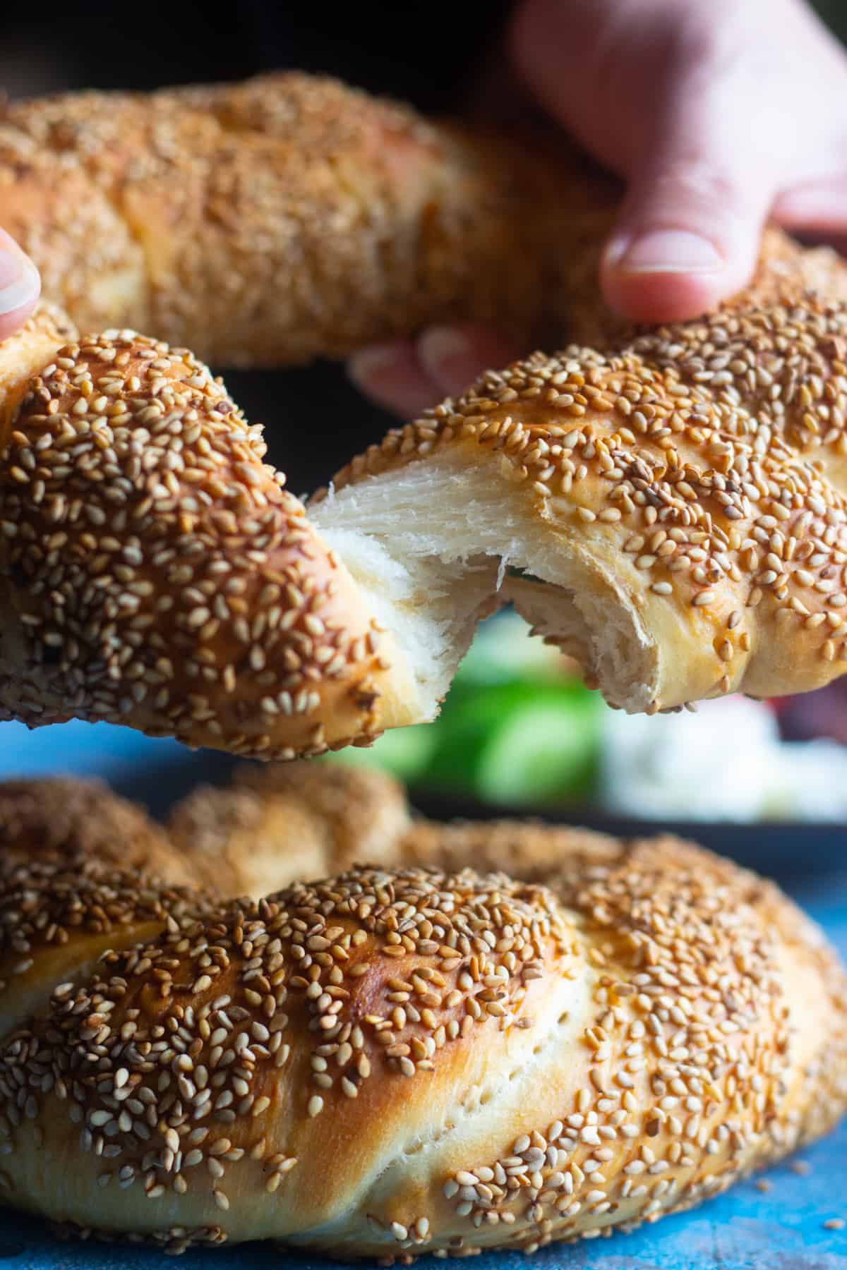 Turkish simit is a delicious sesame crusted bread that you can have for breakfast. Learn how to make traditional simit recipe at home with this step-by-step tutorial. 