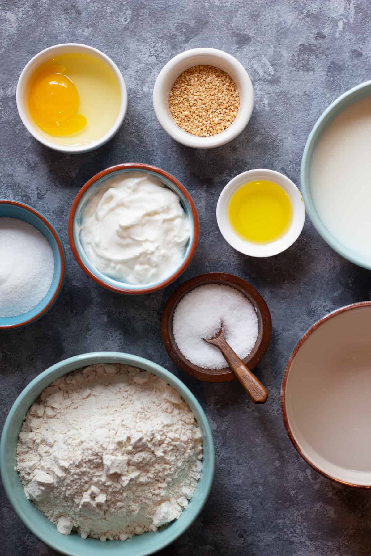 To make this recipe you need water, milk, olive oil, sugar, salt, egg, flour and yogurt. 