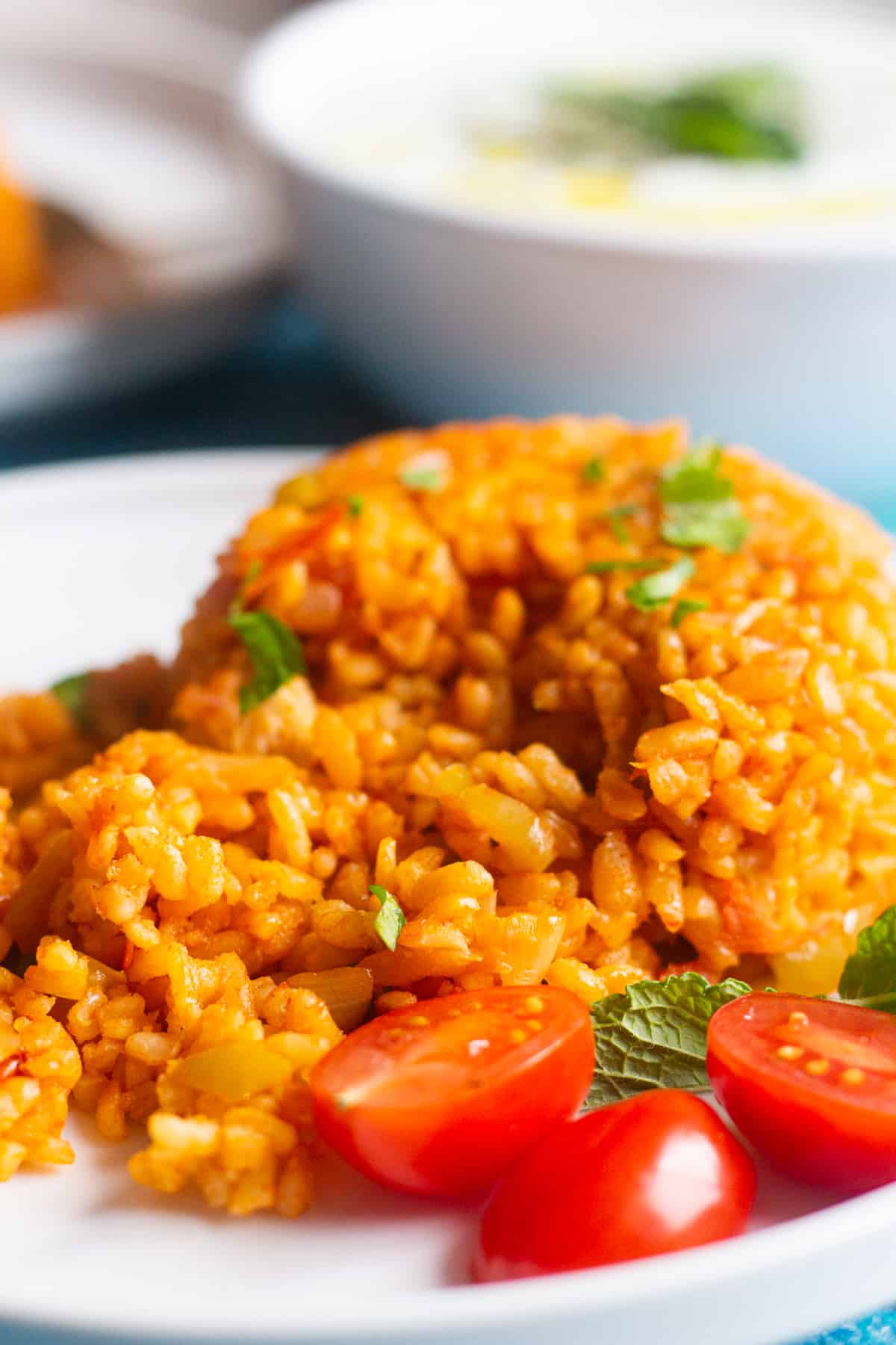 Turkish bulgur pilaf with tomatoes on a white plate