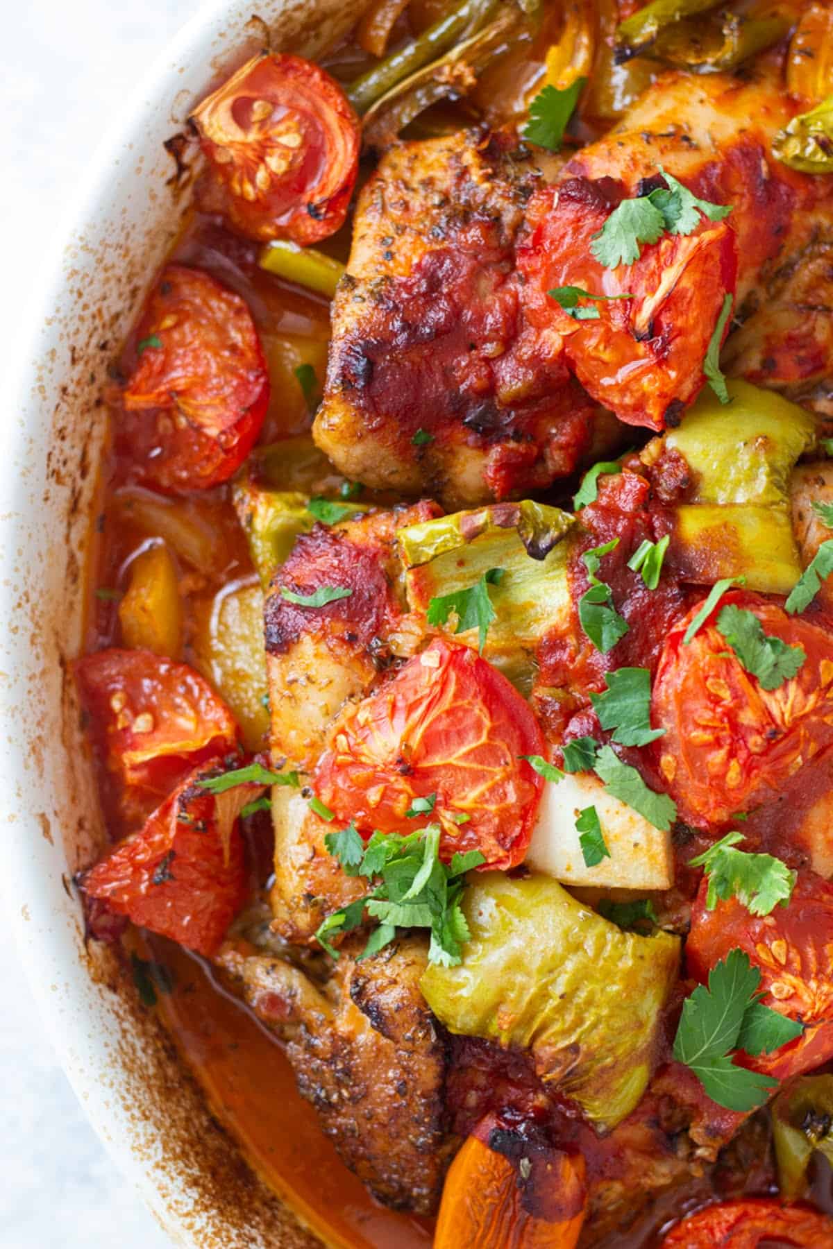 chicken with peppers, tomatoes, onion and potatoes.