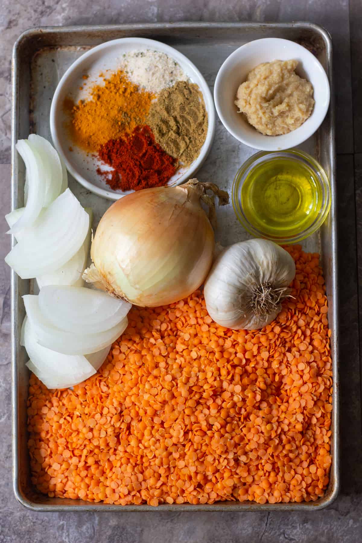 To make spicy red lentil soup you need red lentils, onion, garlic, spices and olive oil.