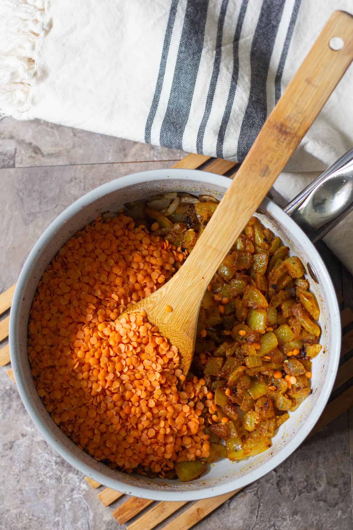 sauté onion and garlic and then add the spices and red lentil. 