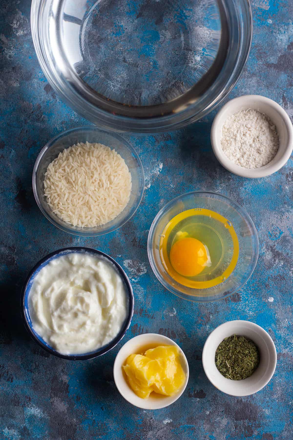 To make warm yogurt soup, you need the following ingredients: Rice: preferably basmati or any long grain. Yogurt: we need plain yogurt, preferably Greek yogurt. Egg Flour Butter Dried mint: you can find dried mint on amazon or at local Middle Eastern and Mediterranean shops.