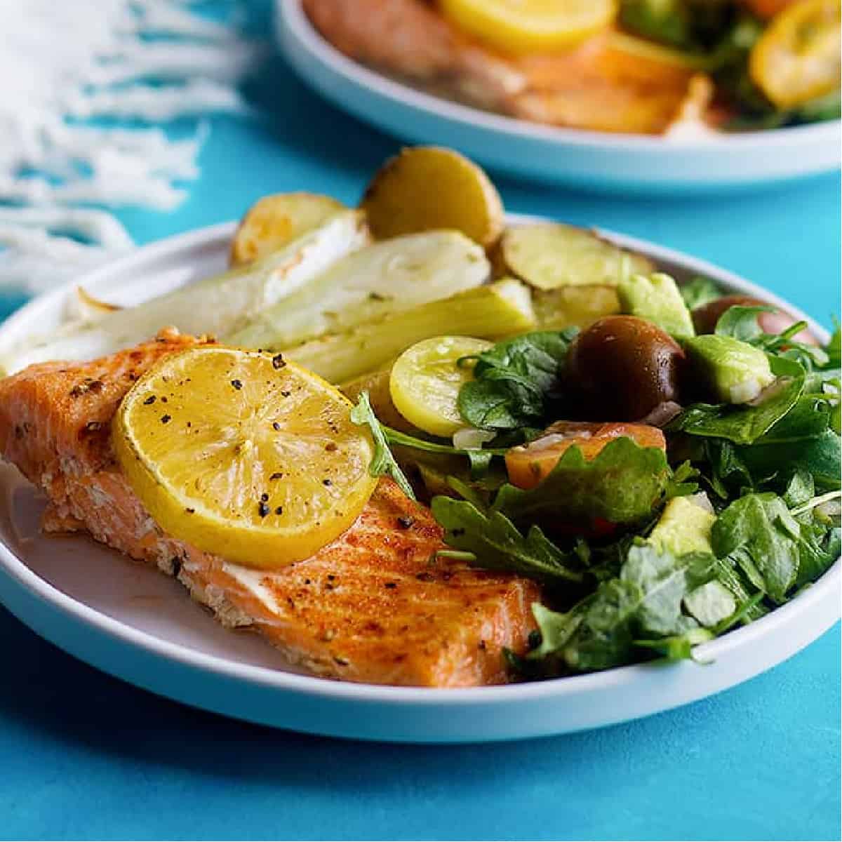 Here is an easy baked salmon fillet recipe. Tender and flavorful salmon fillet are baked on a sheet pan and served with a delicious arugula avocado salad.