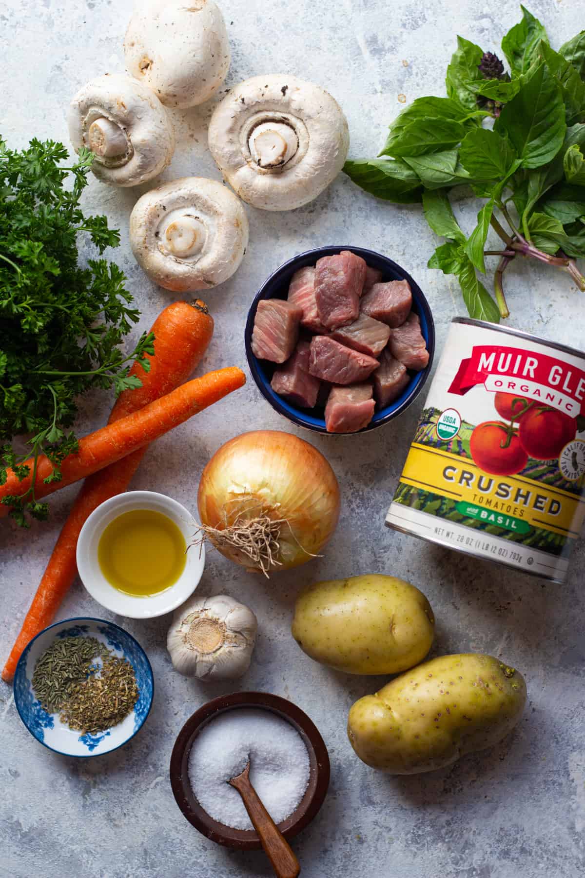 To make beef stew you need beef, mushrooms, tomatoes, carrots, onion, tomatoes and basil.