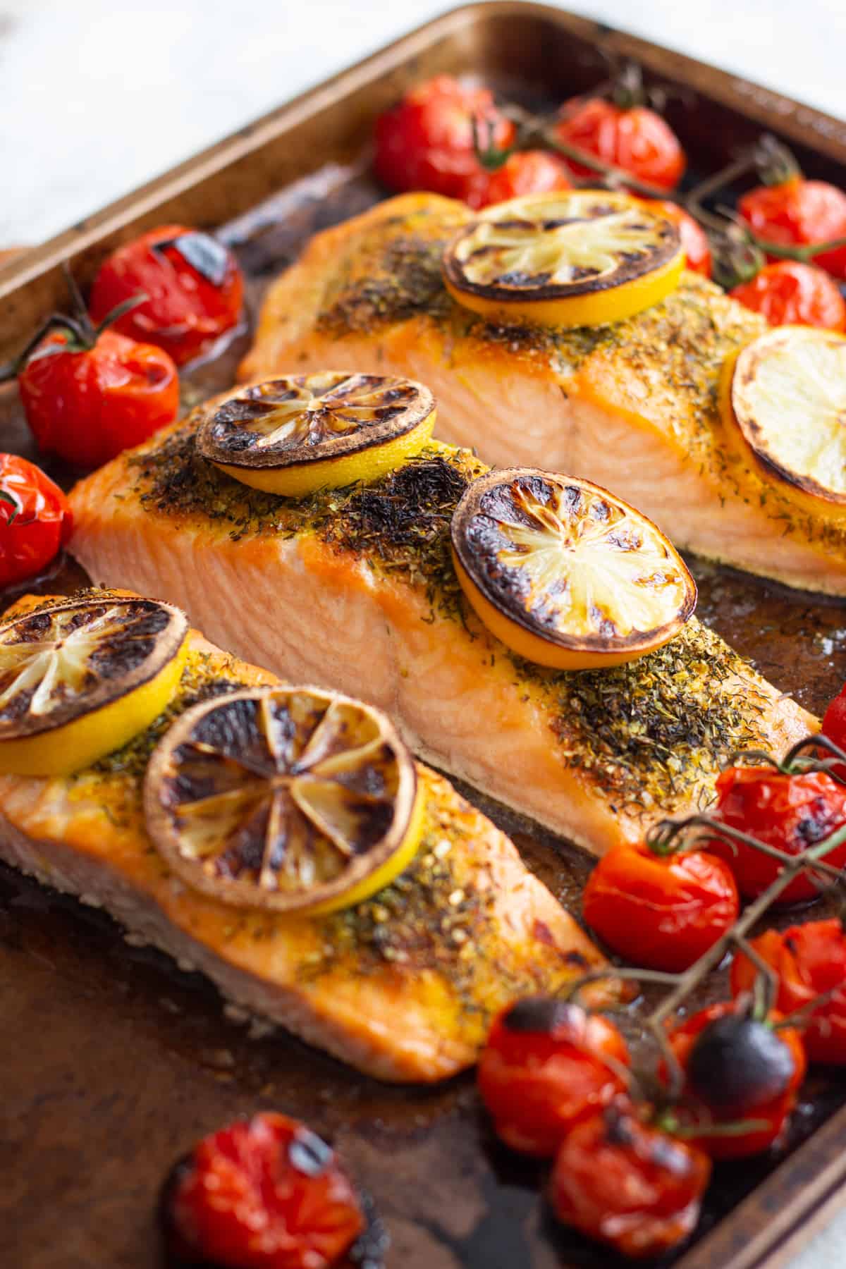 broiled salmon recipe made with salmon fillets and spices on a baking sheet.