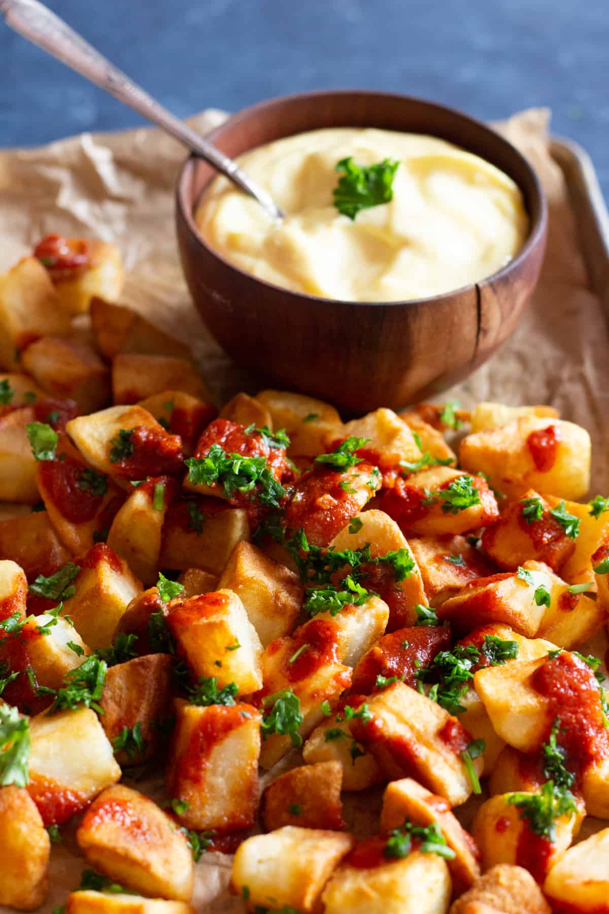 Patatas bravas is a classic Spanish tapas dish. Crispy potatoes topped with spicy tomato sauce and garlic aioli makes a simple but tasty recipe!
