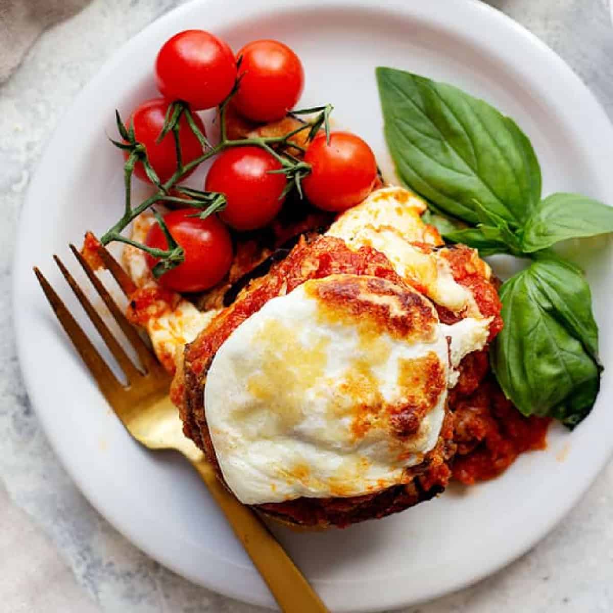 eggplant parmesan on a white plate. 