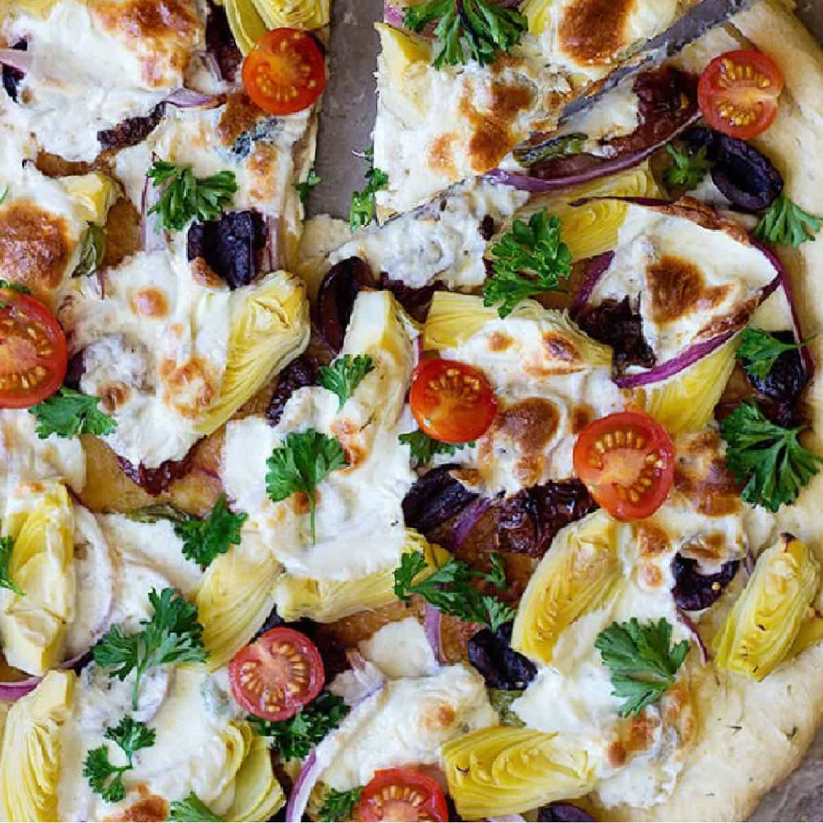 Mediterranean pizza is the ultimate easy fresh family dinner that everyone will devour. This is a delicious homemade pizza recipe with different Mediterranean toppings that would knock your socks off! 
