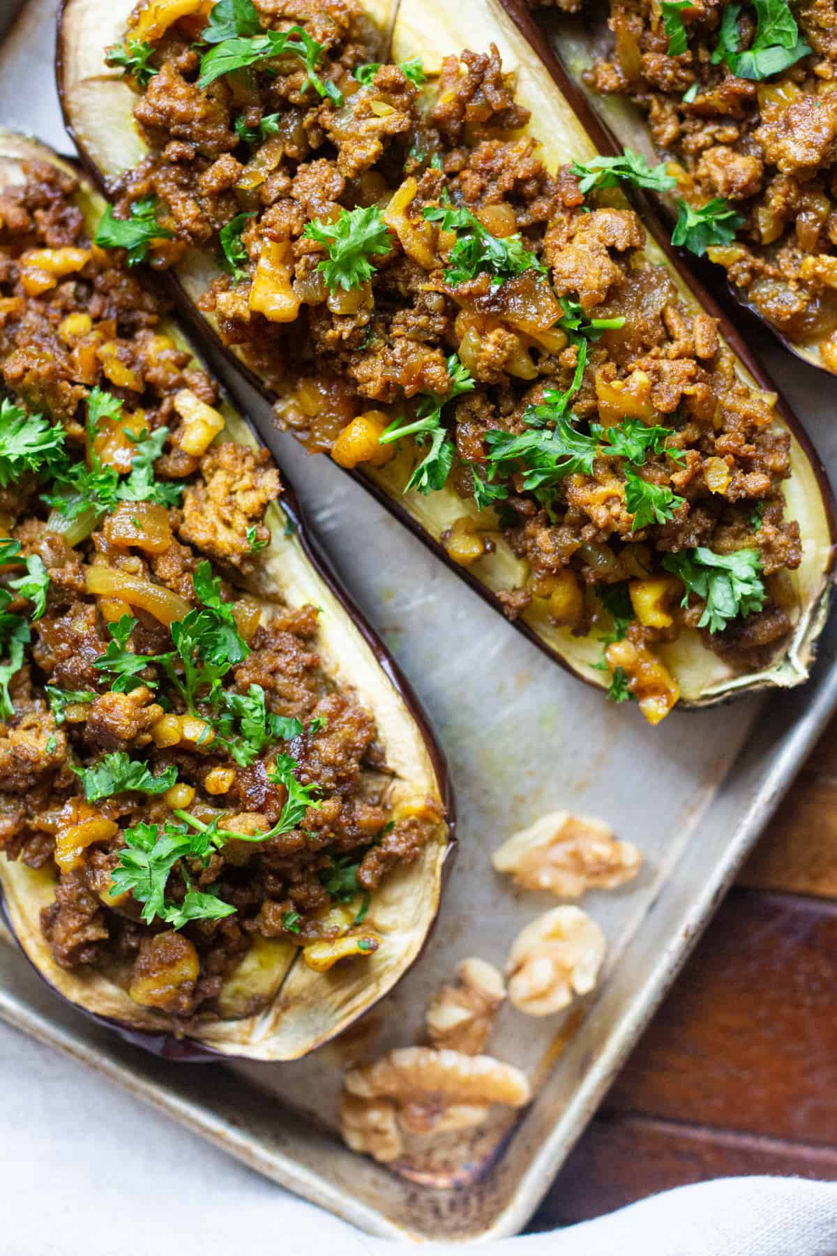 Stuffed Eggplant with Walnuts and Lamb is a family favorite. Juicy eggplants are roasted to perfection, topped with spicy lamb and crunchy walnuts. It's the perfect combination of flavors!