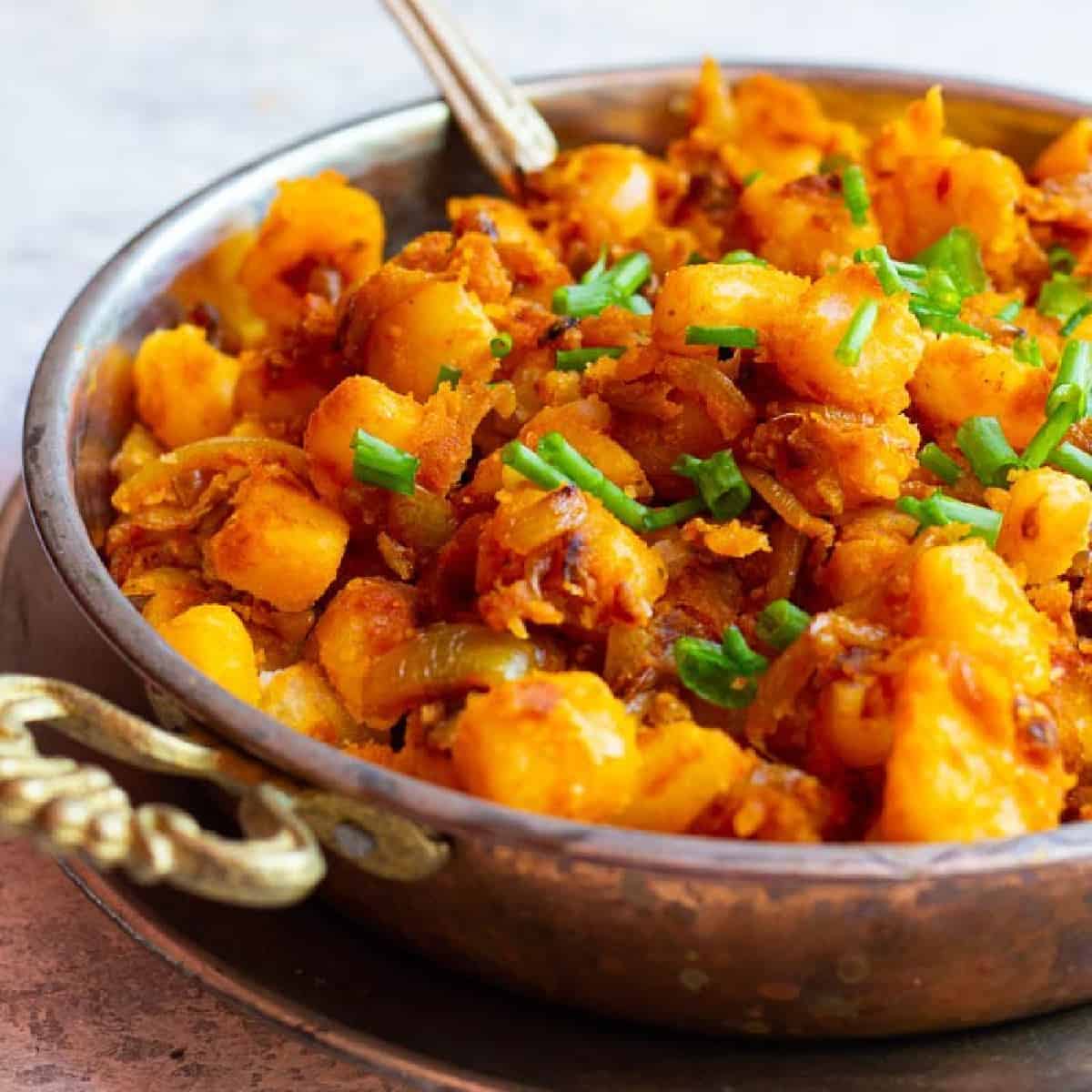 Persian fried potatoes and onions in a pan. 