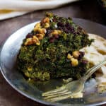 Close up shot of kuku sabzi Persian herb frittata on a plate.