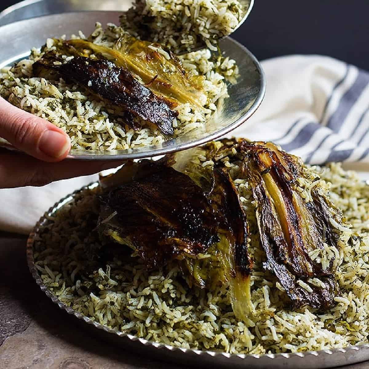 Sabzi Polo is a delicious Persian Herb Rice that is usually served with fish for the new year. Sabzi Polo has a crispy lettuce Tahdig that's hard to resist! 
