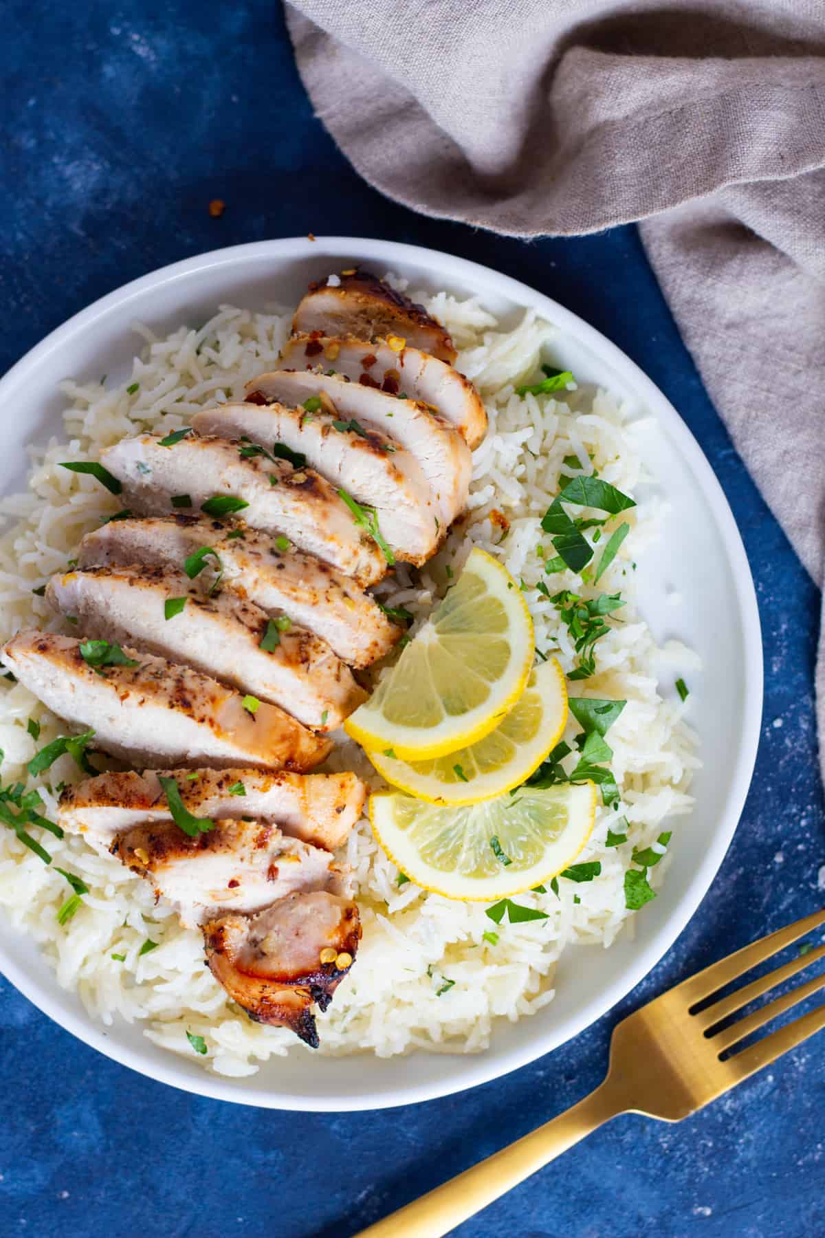 Greek style baked chicken served with rice and lemon. 