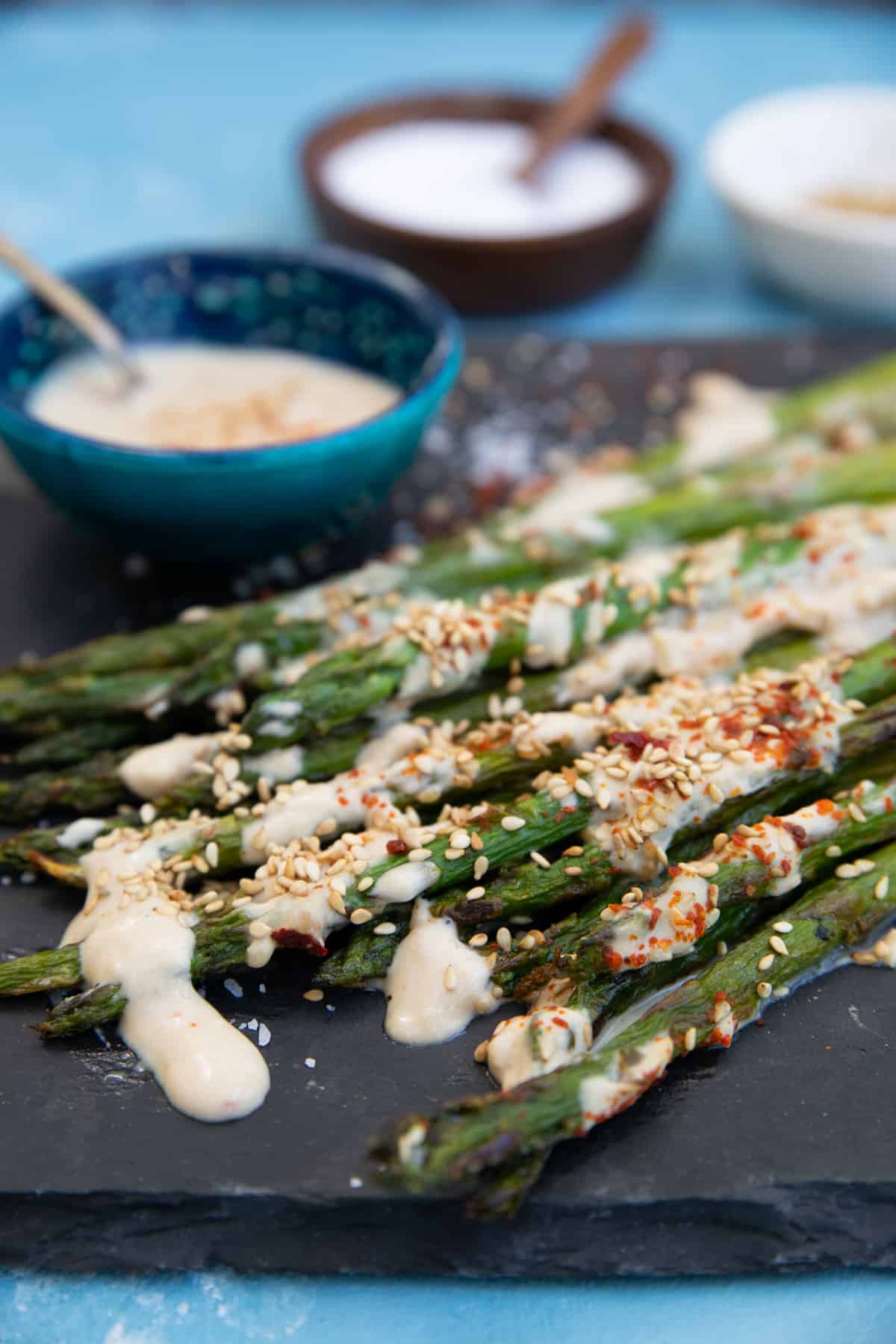Close up shot of a plate of grilled asparagus. 