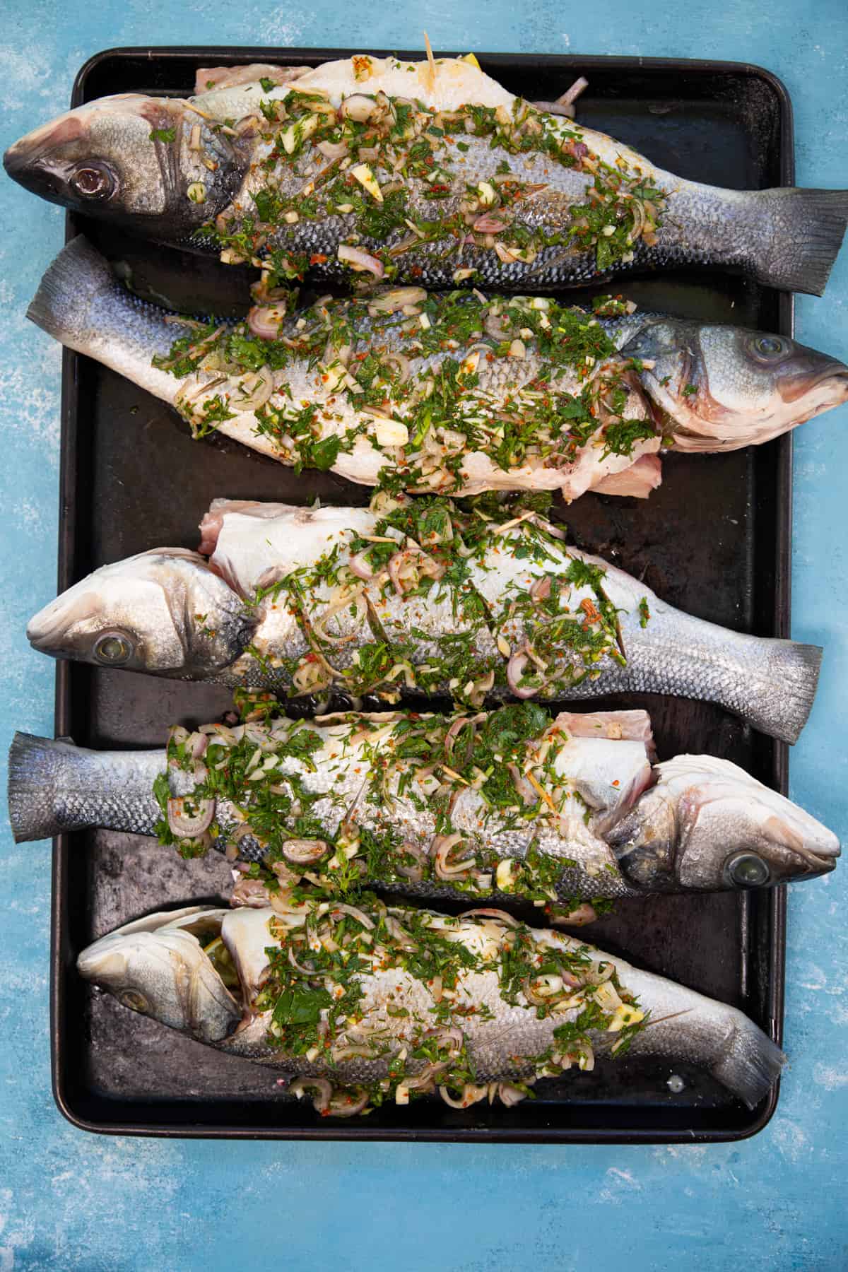 Overhead shot of European seabass topped with lemon herb marinade. 