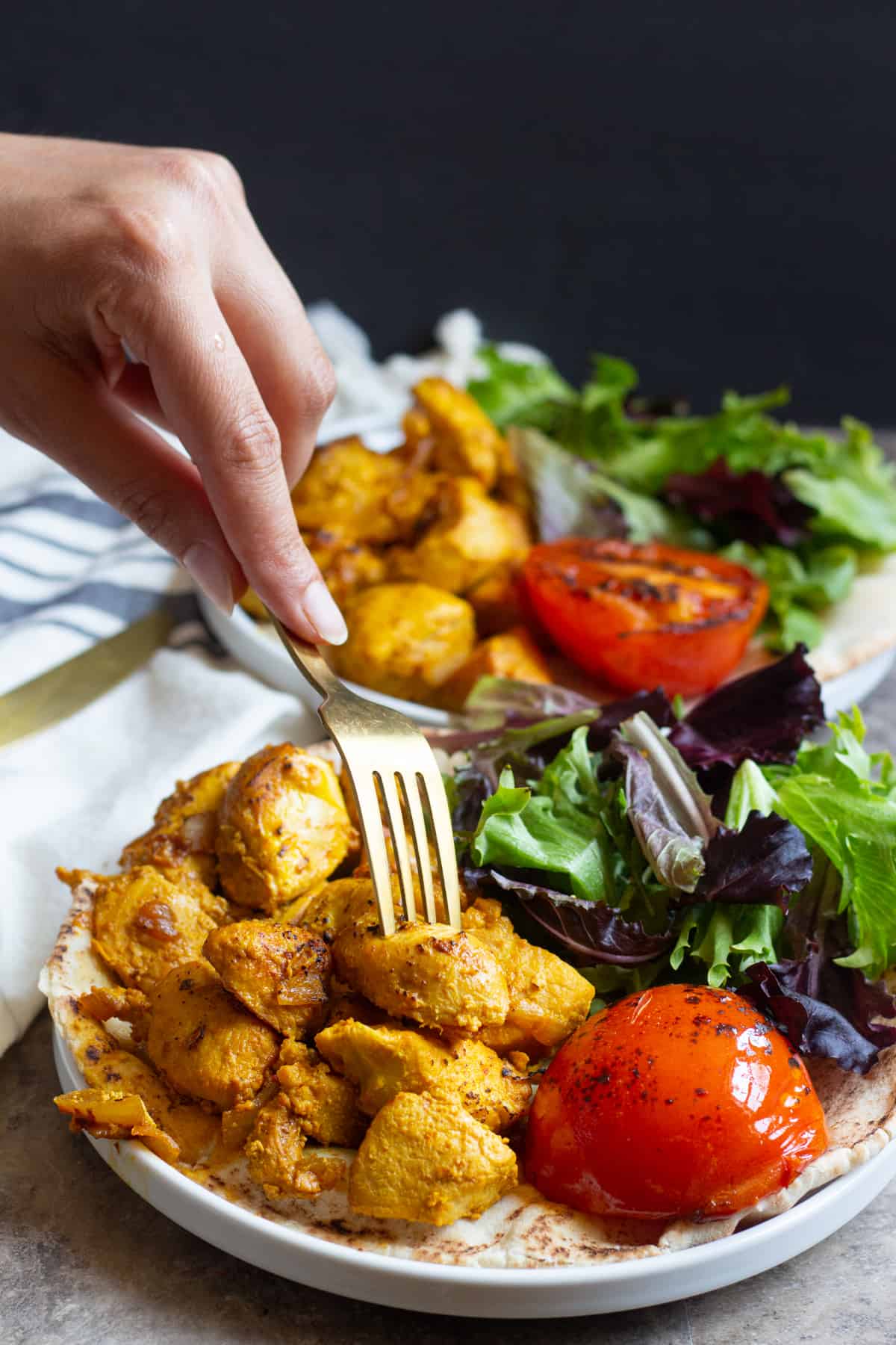 fork inserted into grilled saffron chicken kabobs. 