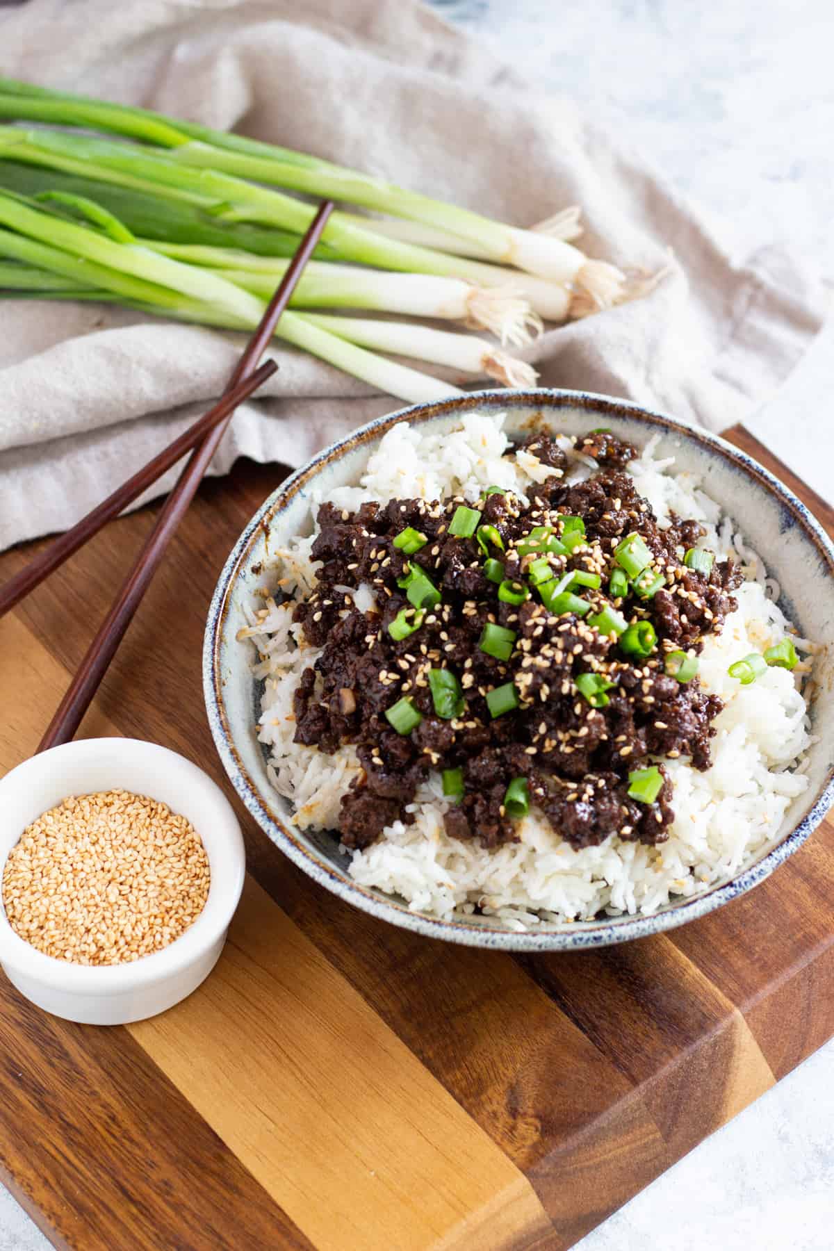 Top the dish with green onions and sesame seeds. 