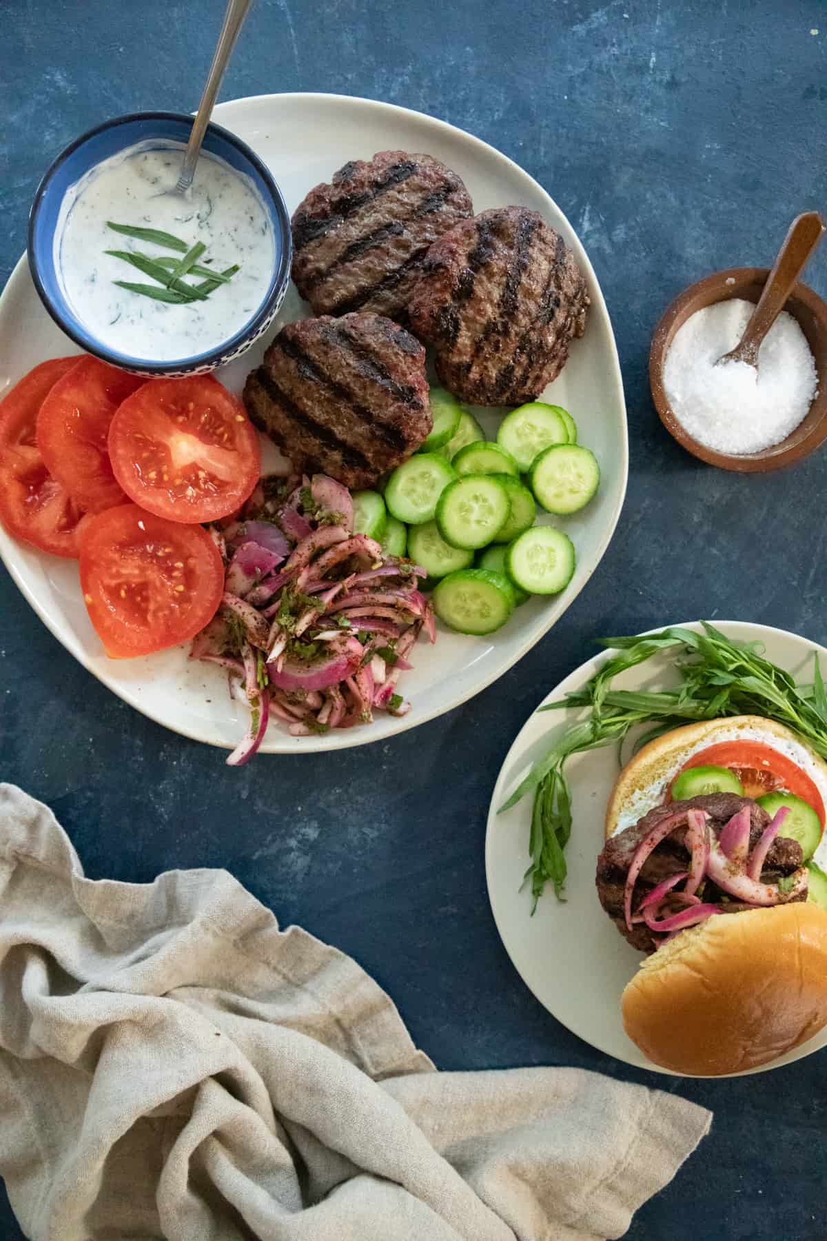 lamb burger patties on a plate with vegetables. 