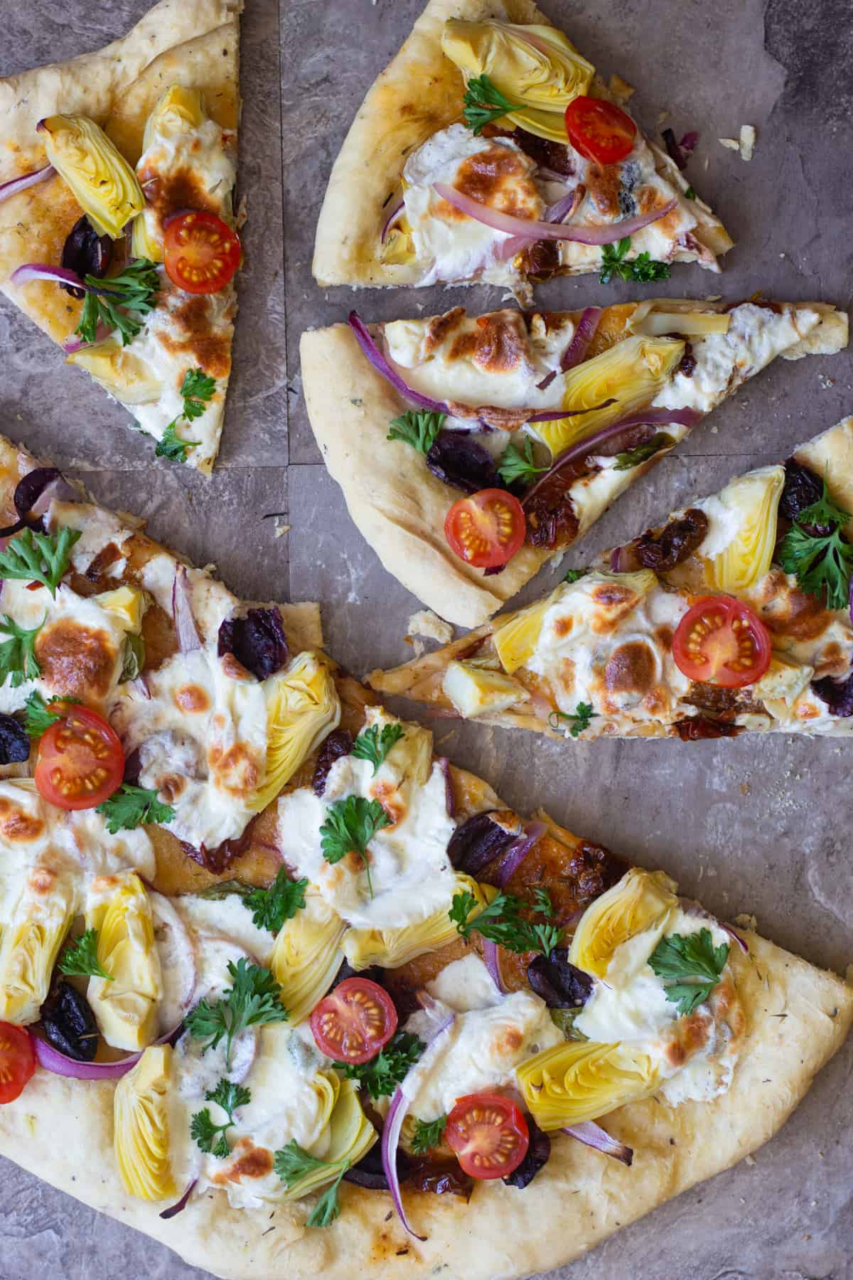 overhead shot of a pizza with Mediterranean toppings. 