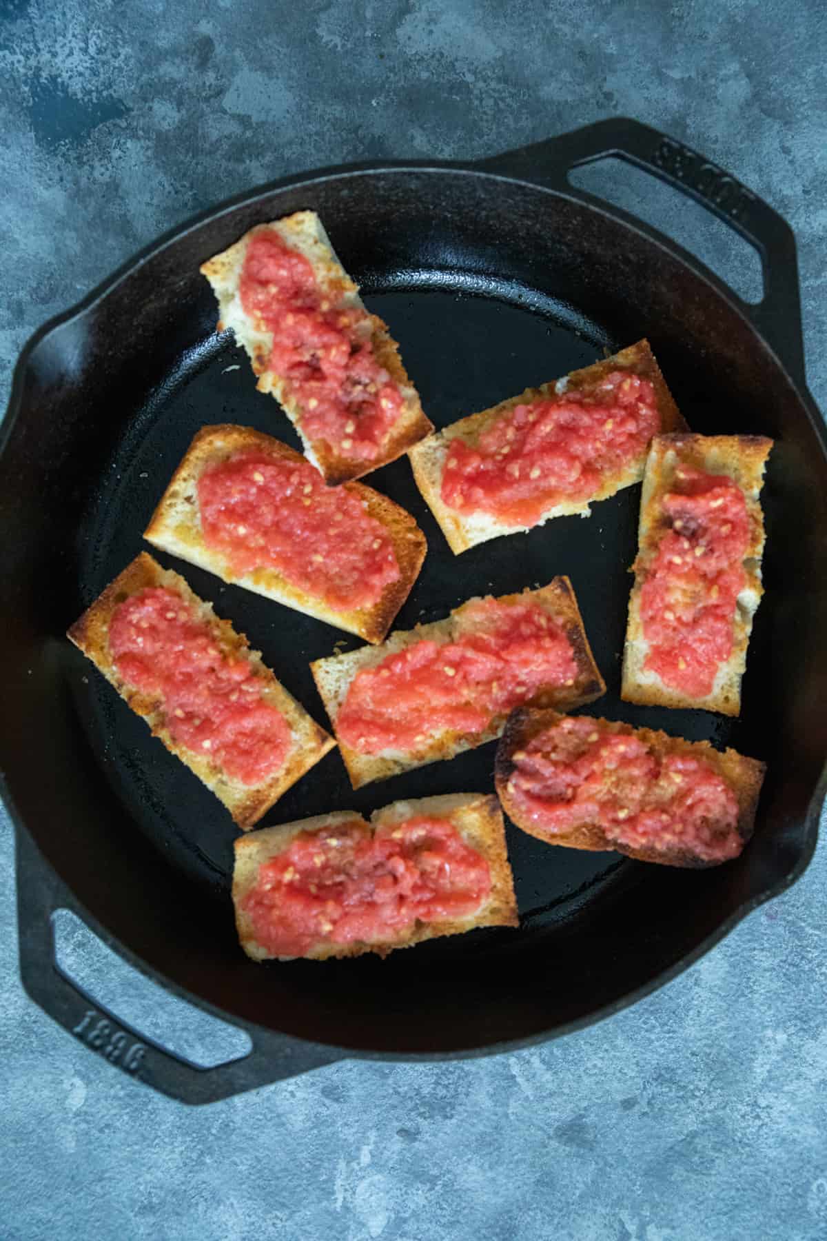 Spanish tomato bread in a cast iron skillet. 