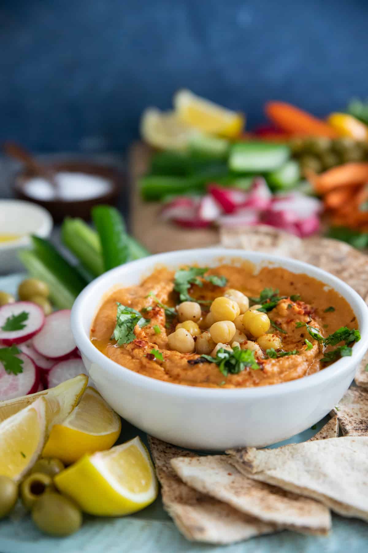 Roasted red pepper hummus is easy and has a nice flavor. The sweetness of roasted red peppers combined with tahini, chickpeas and lemon juice makes a tasty hummus that's perfect for a mezze spread.
