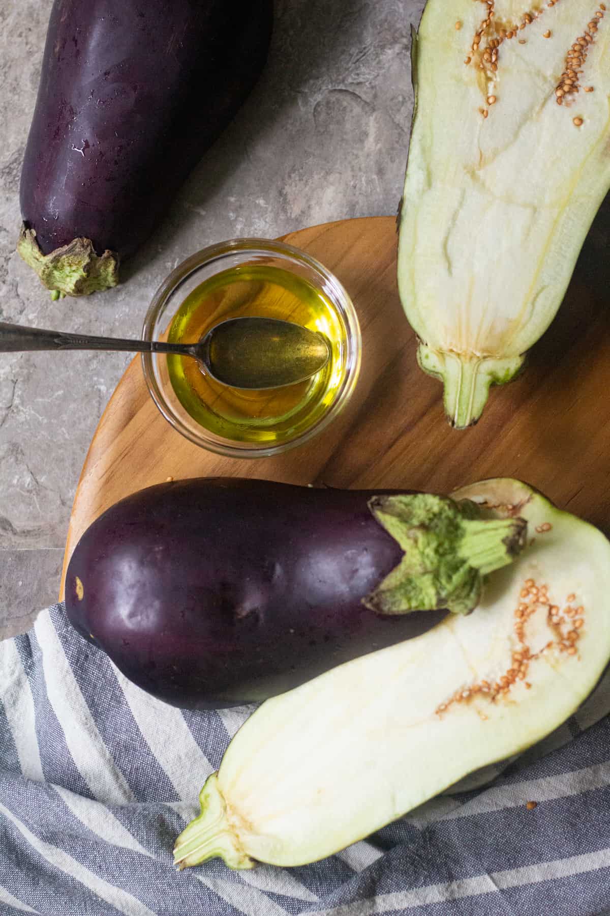 To roast eggplant cut them in half and brush with olive oil. 
