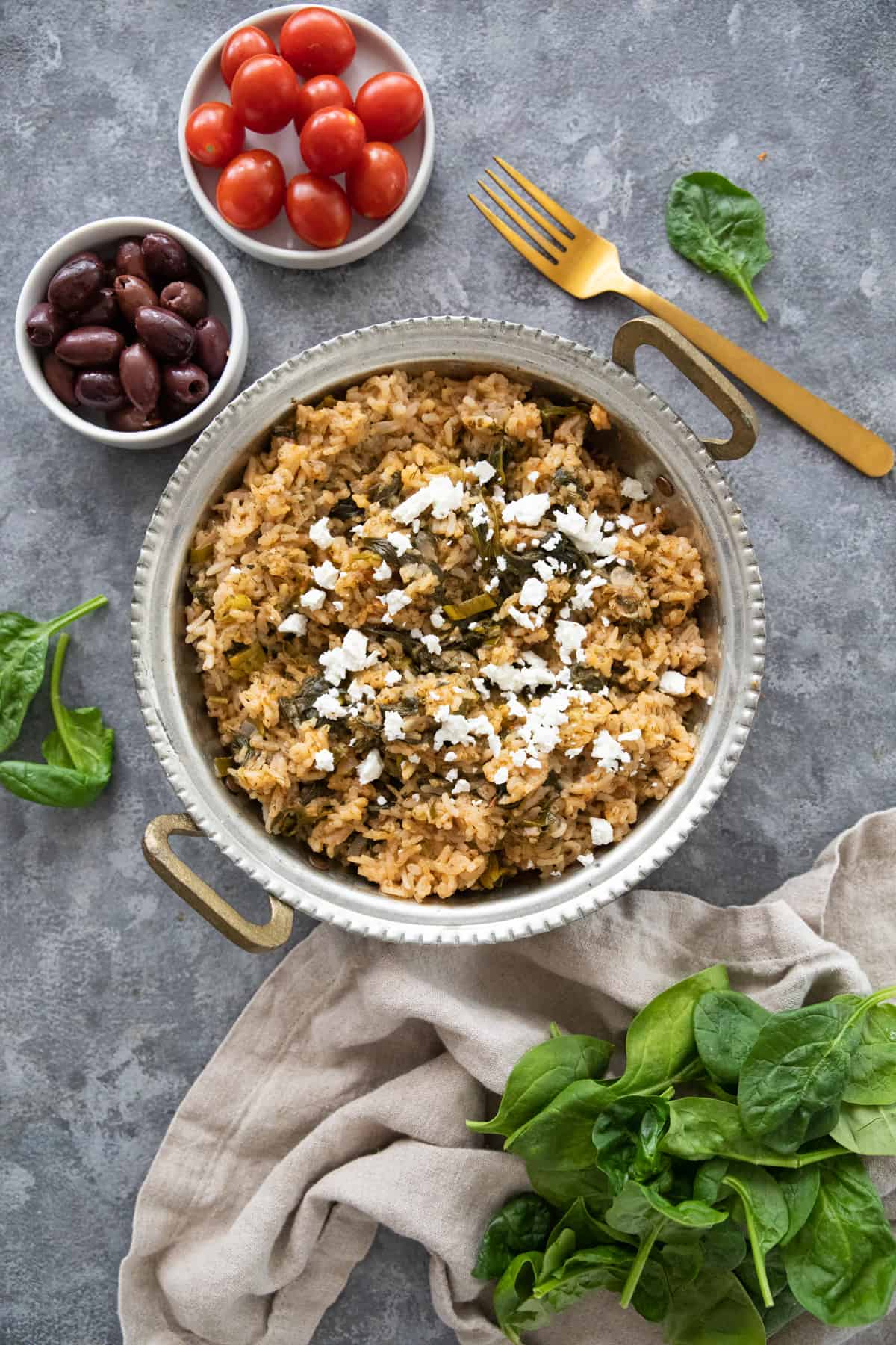 Spanakorizo is a classic Greek spinach rice that's easy and comforting. You only need a few ingredients to make this delicious vegetarian recipe.
