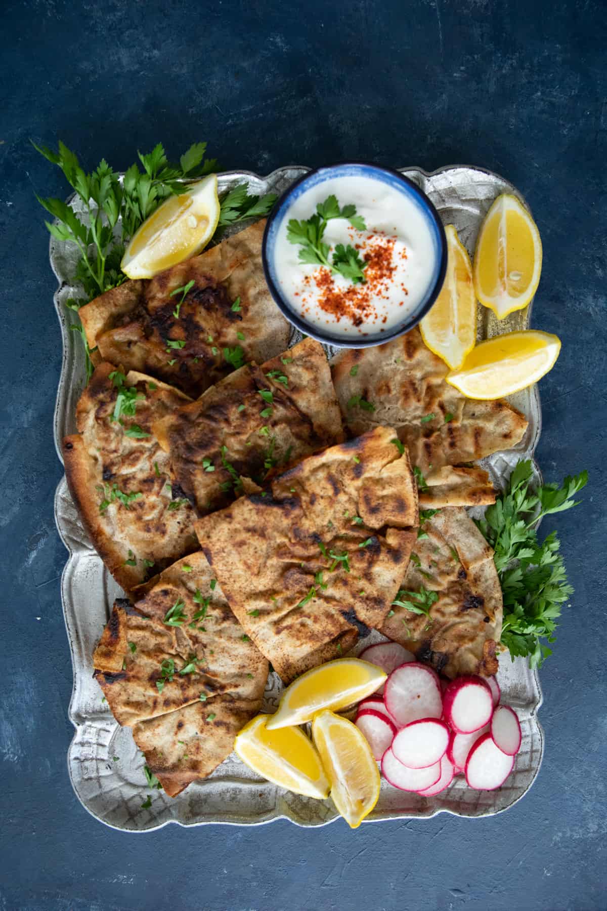 overhead shot of arayes on a platter on a dark backdrop. 