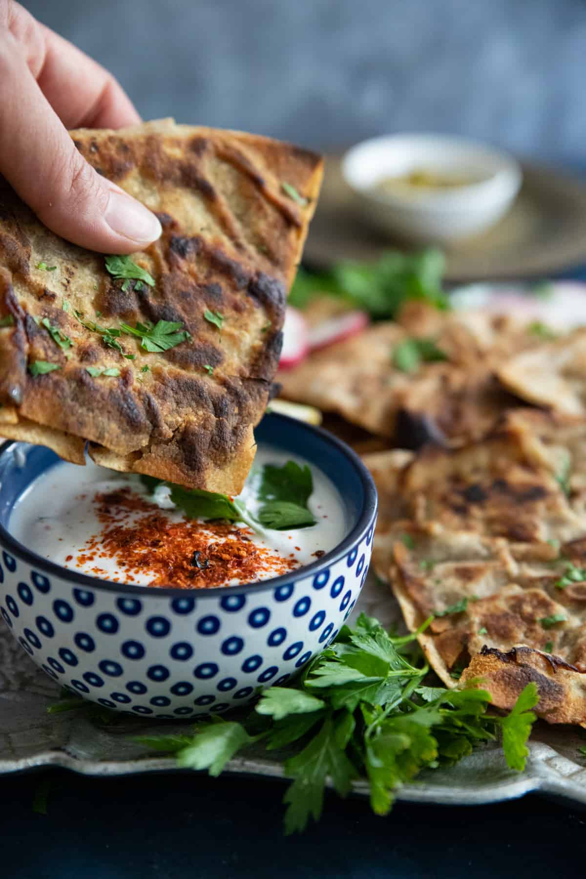 A piece of Lebanese stuffed pita dipped into yogurt. 