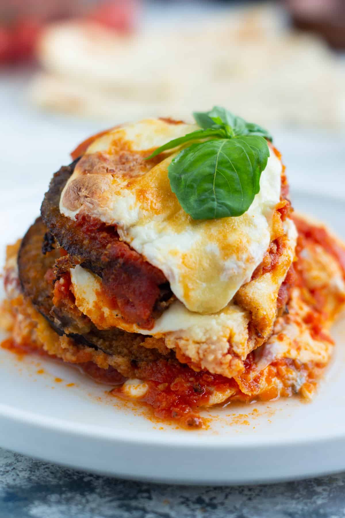 layers of fried eggplant with melted mozzarella cheese and tomatoes.