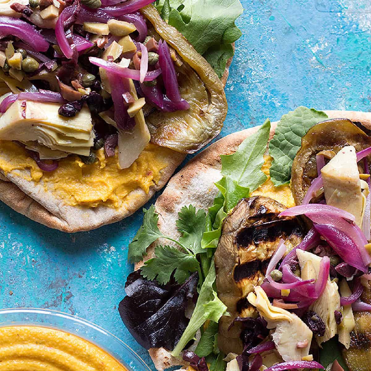 Grilled eggplant sandwich is the perfect lunch. This sandwich is made with grilled eggplants, olives, onions, capers, hummus and other delicious ingredients.
