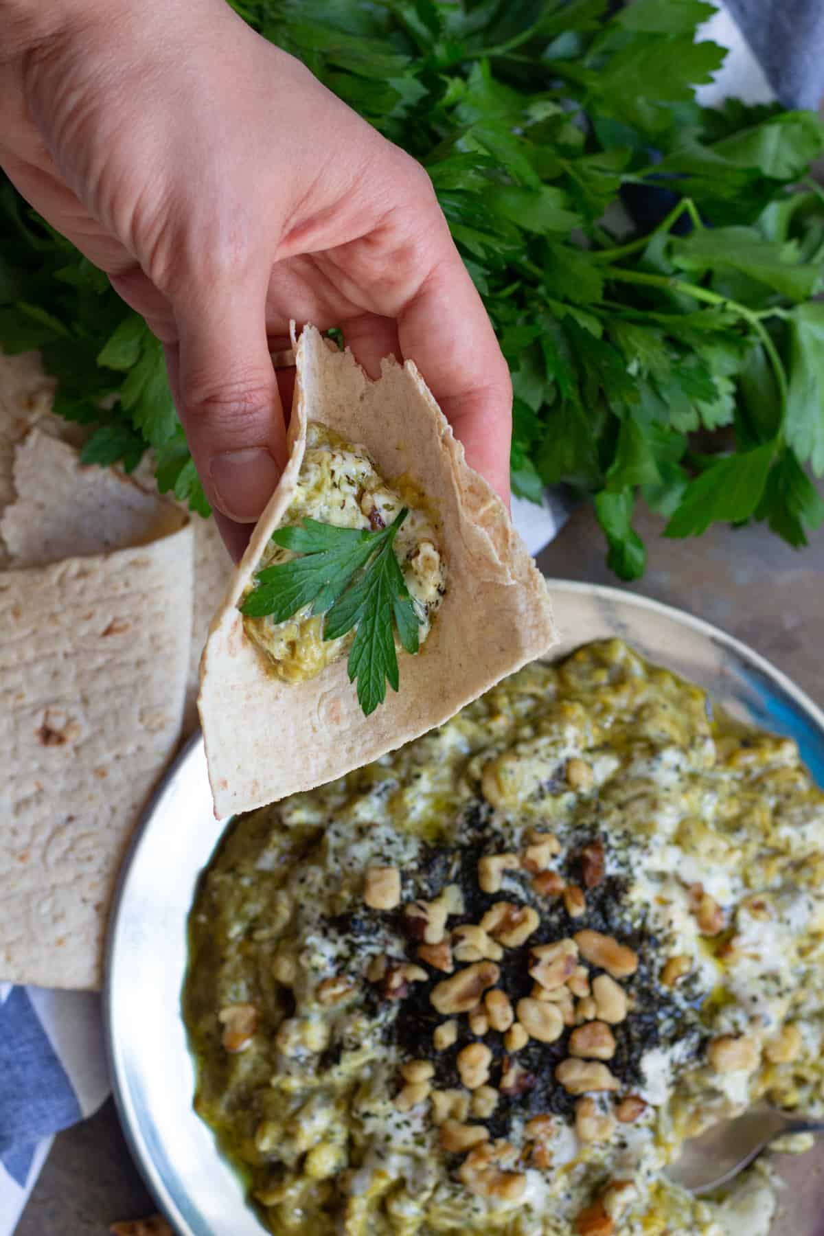Serve kashke bademjoon with lavash bread and parsley or any other herbs.
