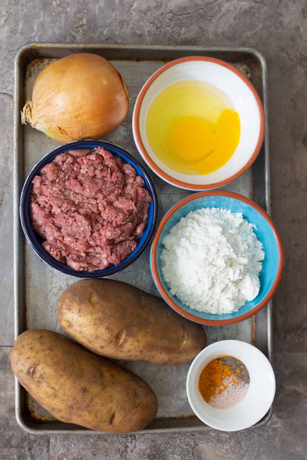 To make Kotlet, you need ground beef, potatoes, onion, egg, spices and flour. 