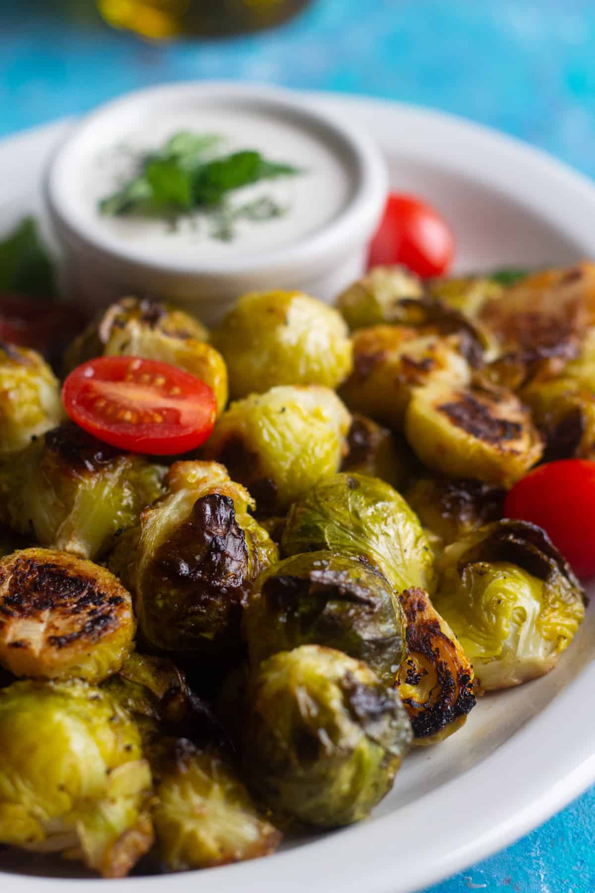 Oven roasted brussel sprouts are easy and ready in 20 minutes. Crispy brussel sprouts roasted in the oven with lemon and garlic make a great side dish. 
