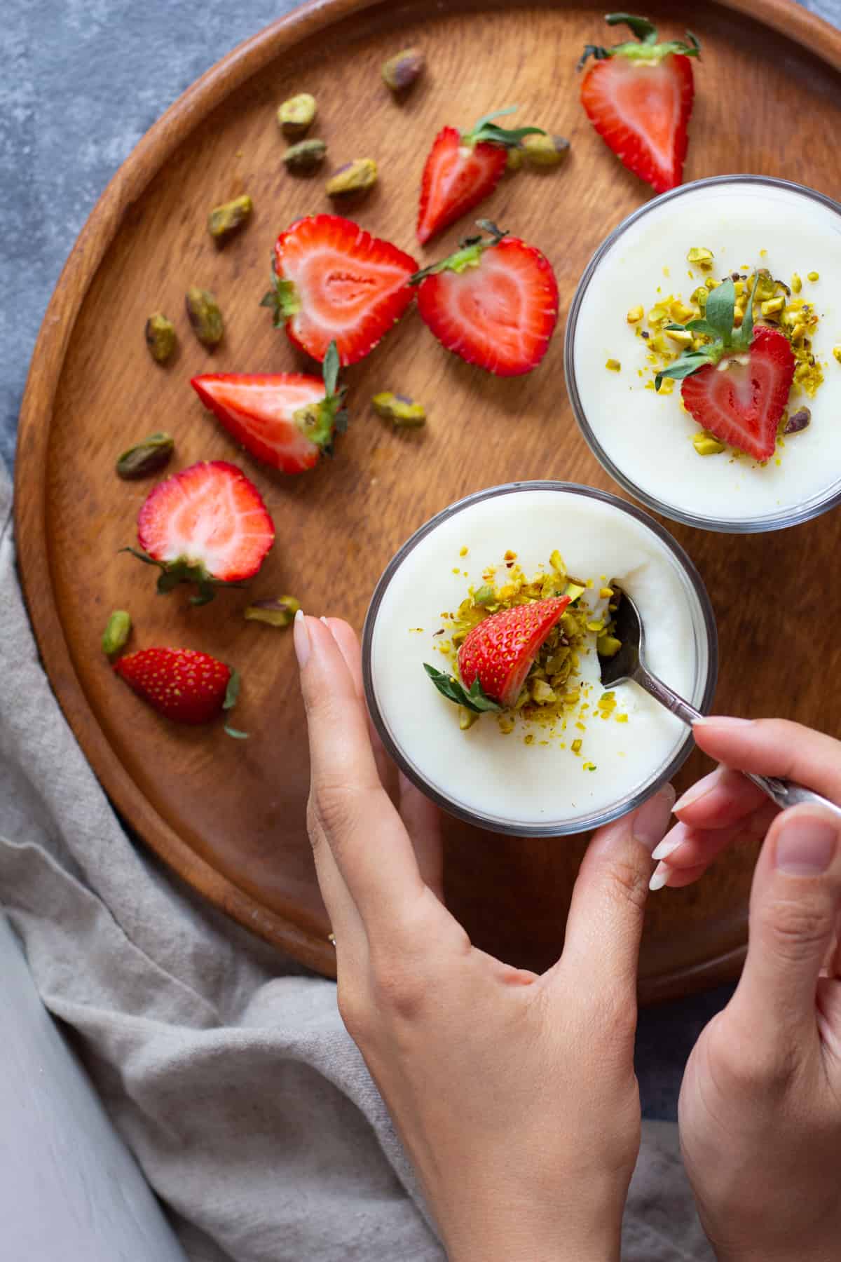 A spoon into a cup of mahalabia. 