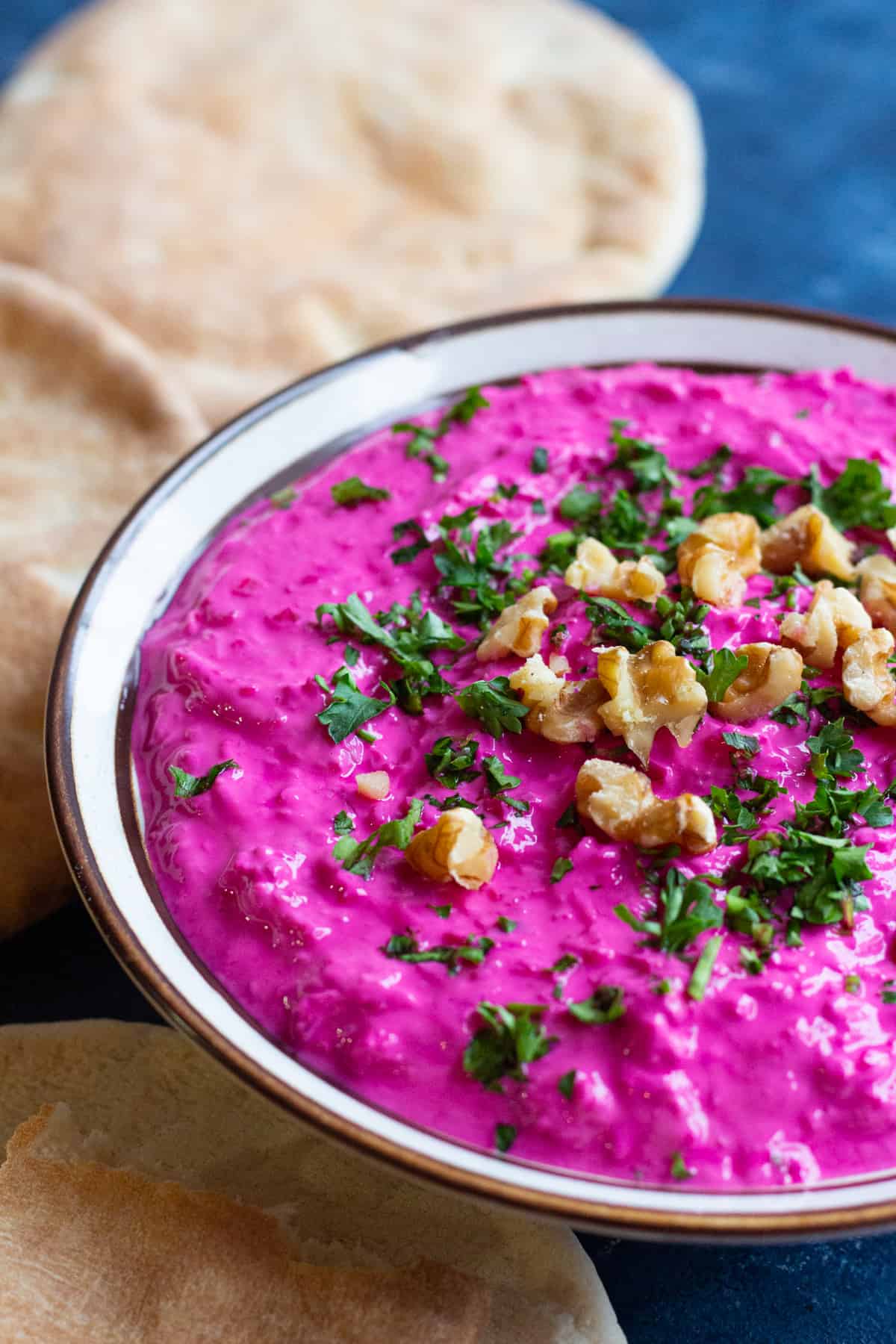 yogurt beet dip on a blue surface. 