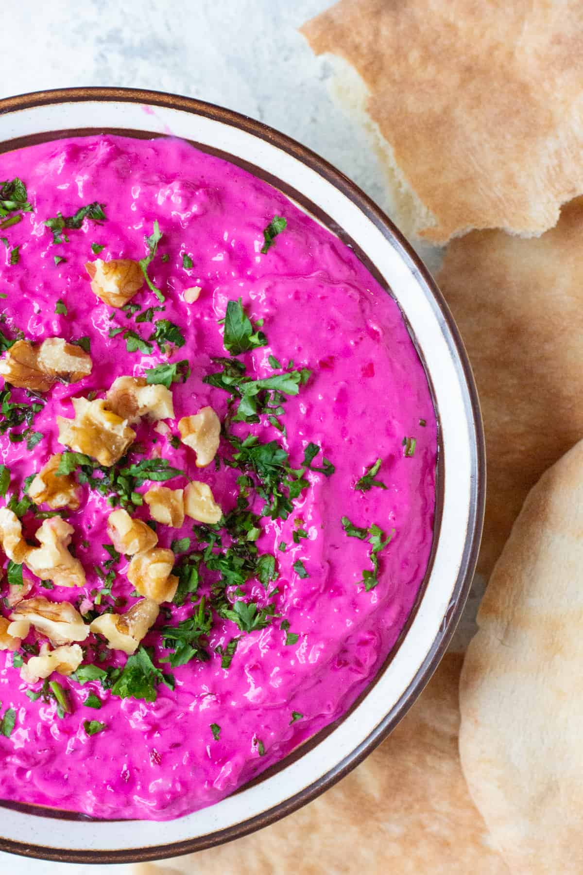 close up shot of beet dip with pita.